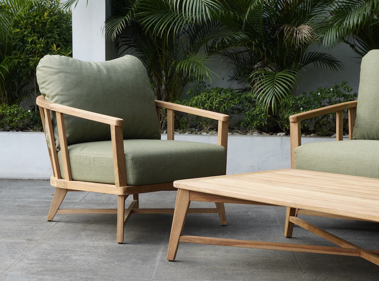 Green outdoor lounge chairs in a garden setting